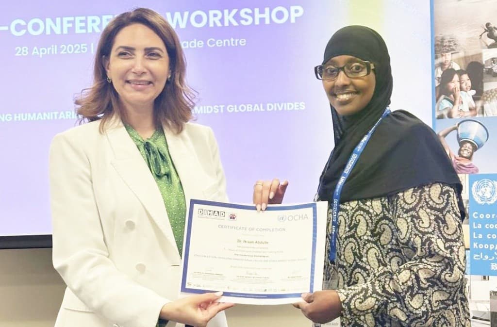 Dr. Ikraan Abdulle receiving a certificate of completion at the DIHAD conference workshop